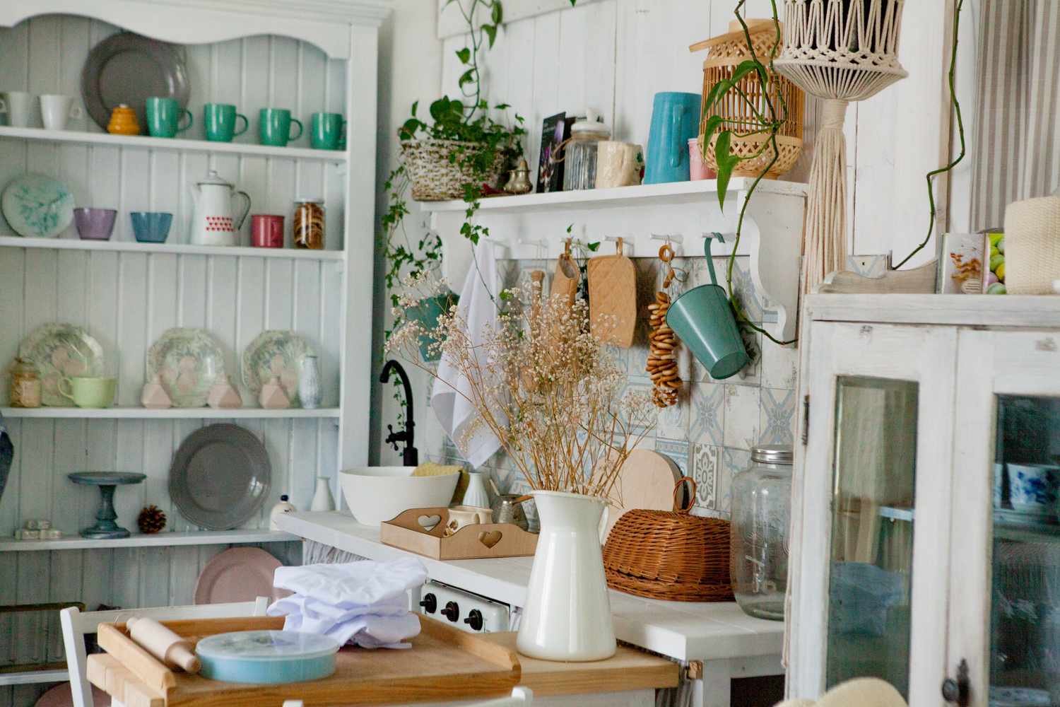 Stylish and sunny interior of kitchen space with small wooden table at the photo studio.