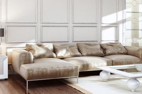 A luxuriously styled living room with a contemporary sectional sofa and a rectangular coffee table with spherical legs