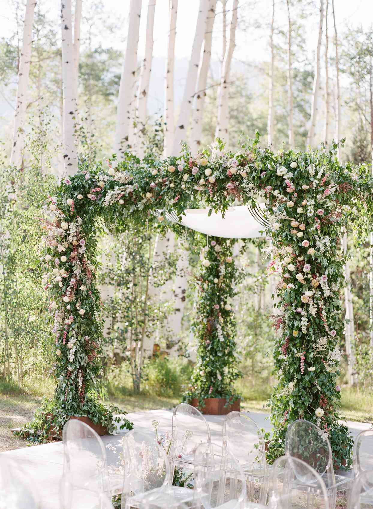 wedding ceremony chuppah embellished with colorful flowers and greenery