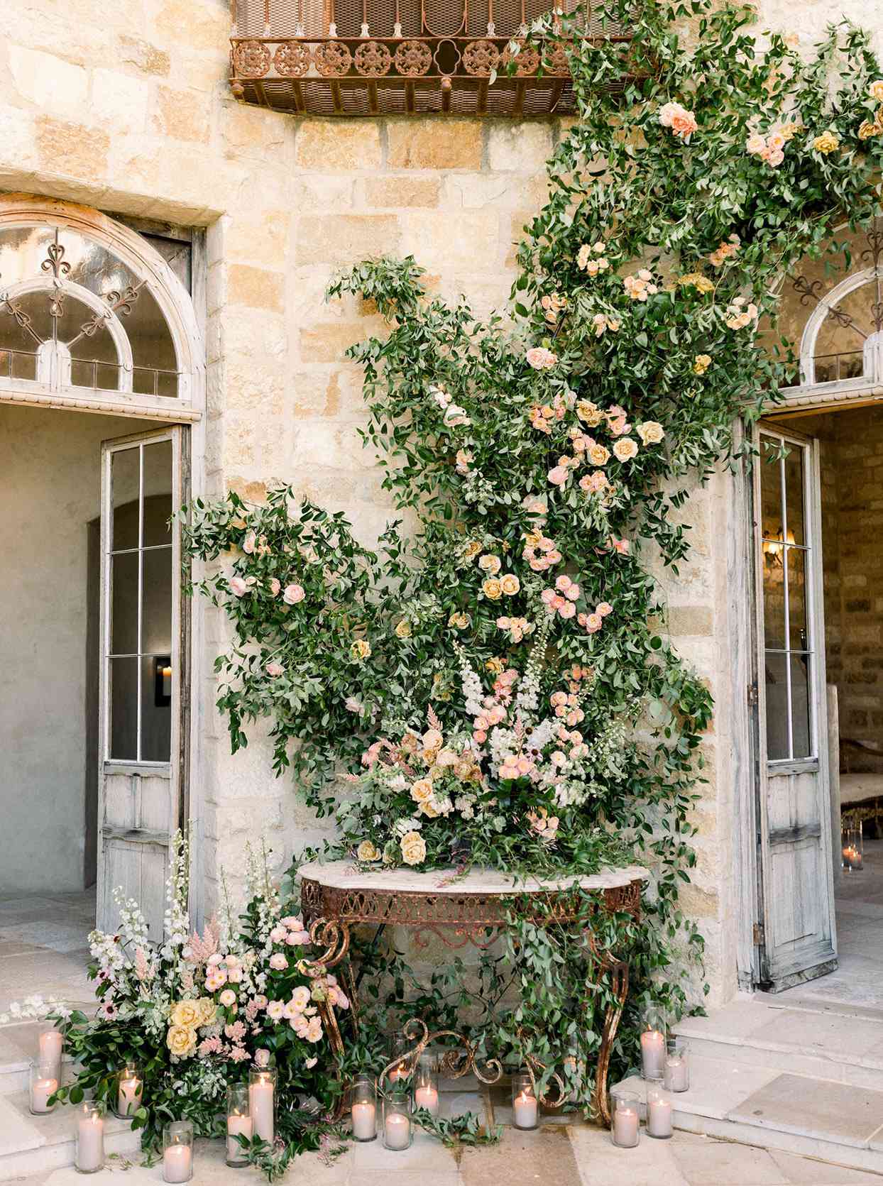 Wedding decor with cascade of greenery with flowers and candles