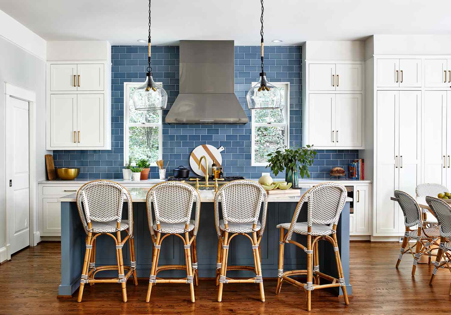kitchen with blue subway tile backsplash and woven vinyl bar stools