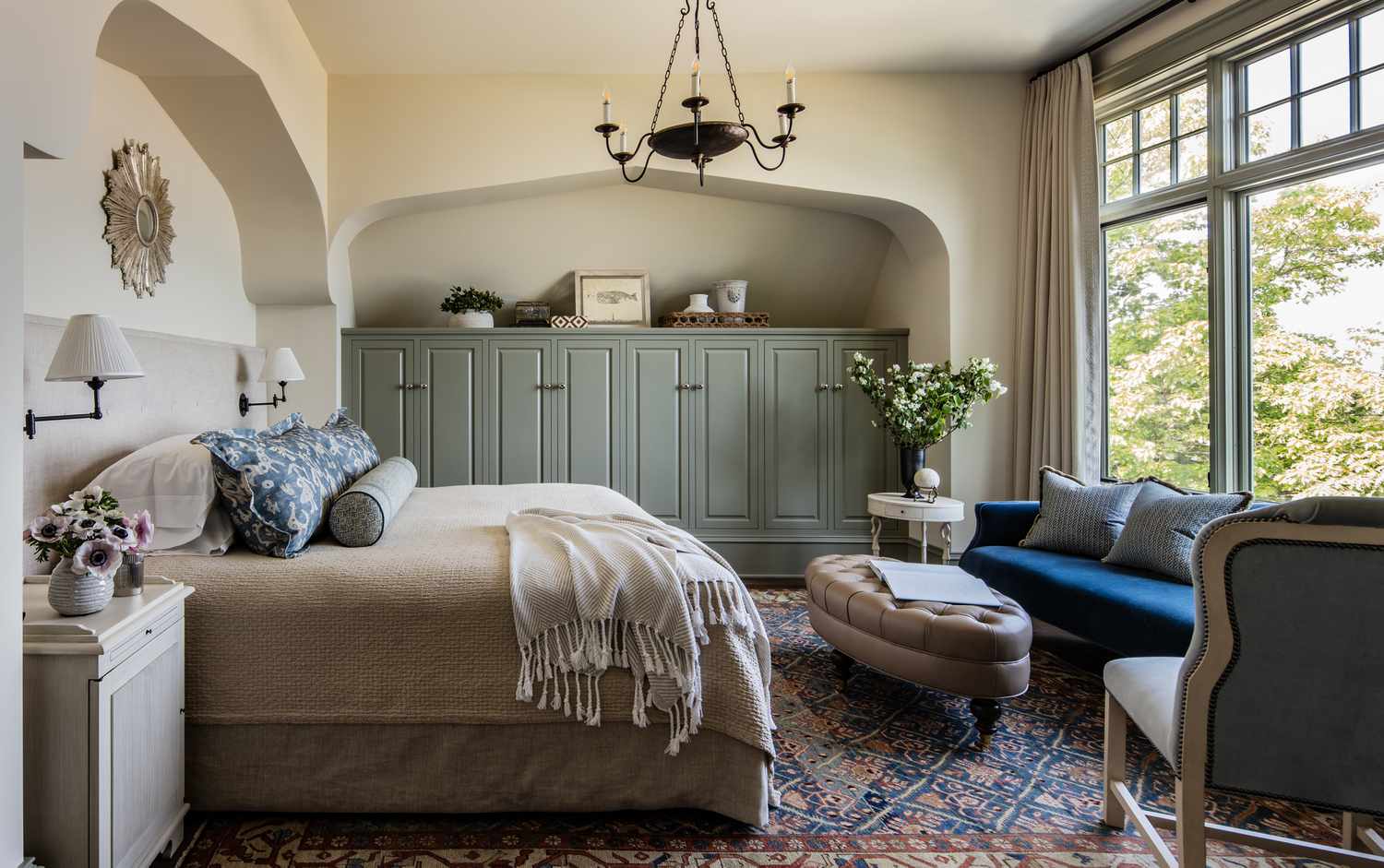 neutral bedroom with vintage elements and chandelier