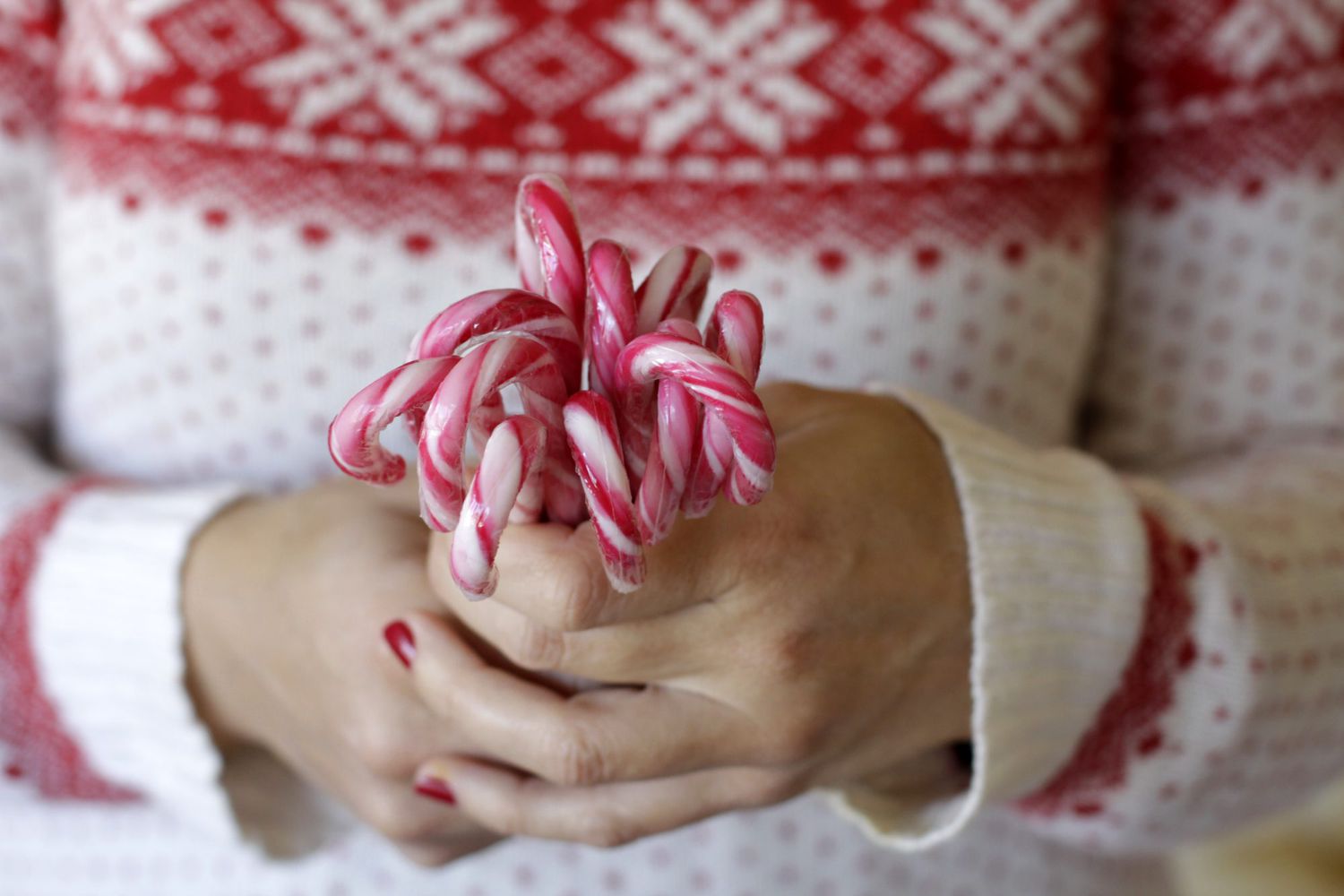 woman holding candy canes