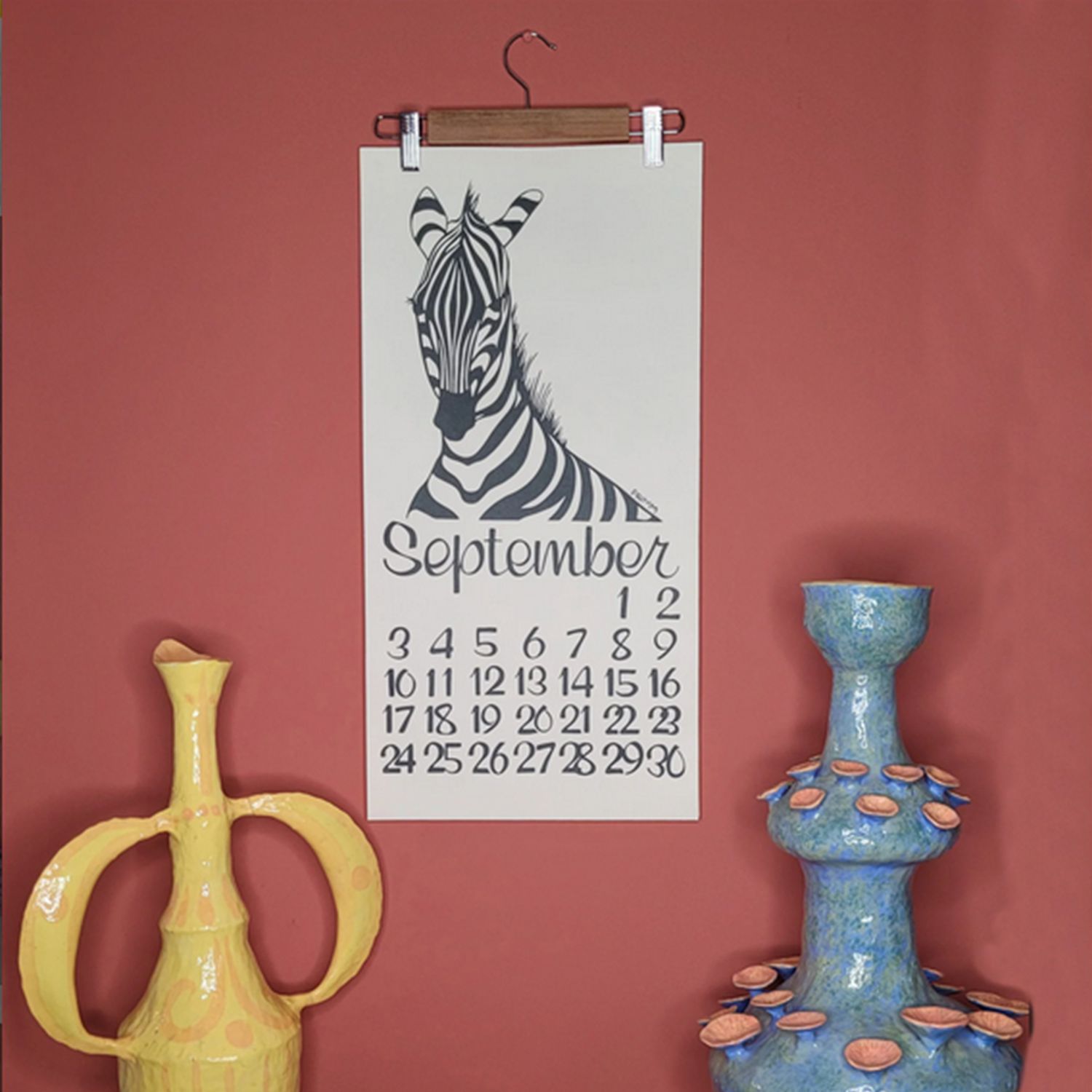 zebra calendar on a red wall