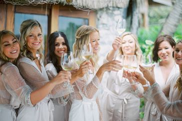 wedding bridal party getting ready and toasting white