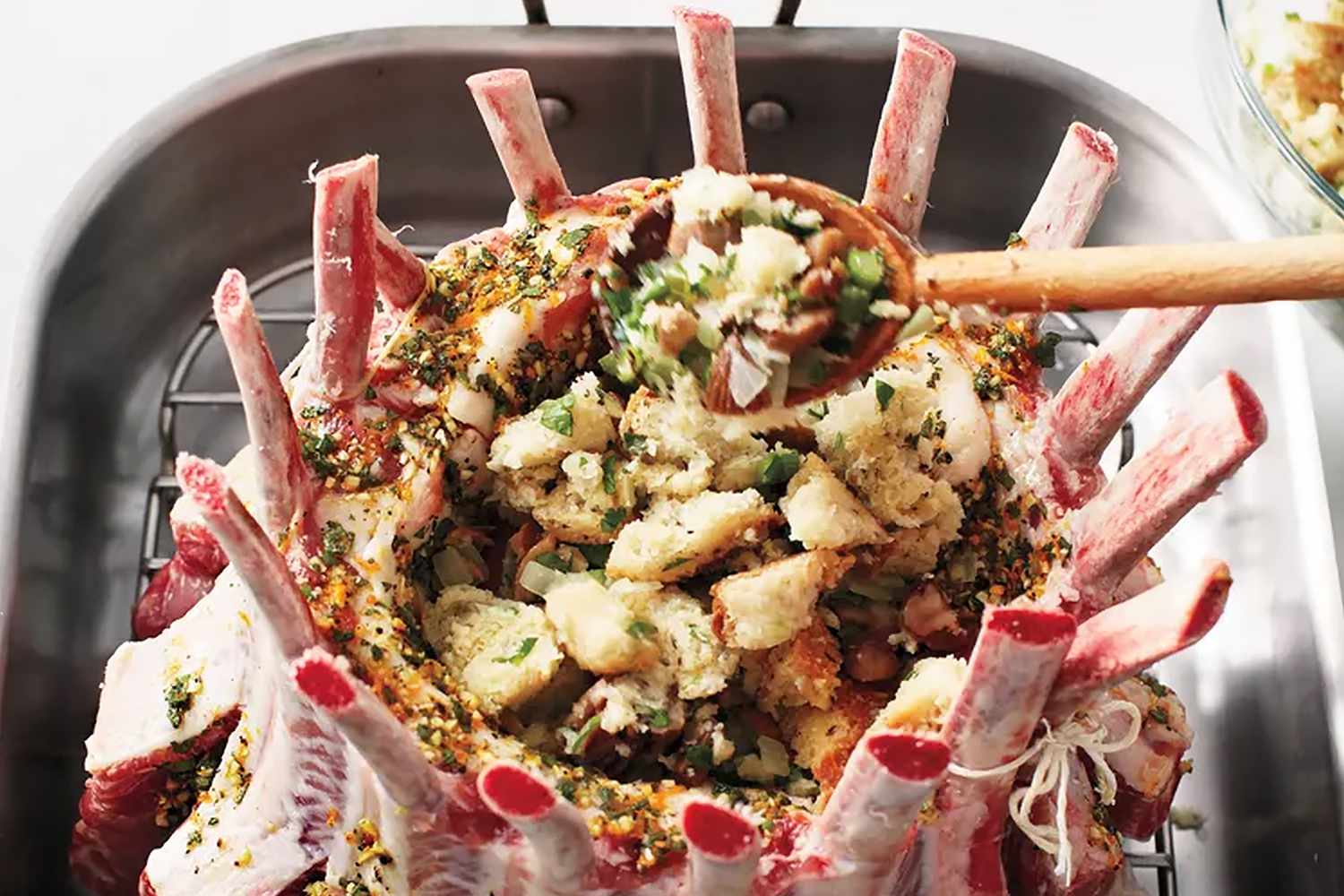 overhead view of someone stuffing a pork roast