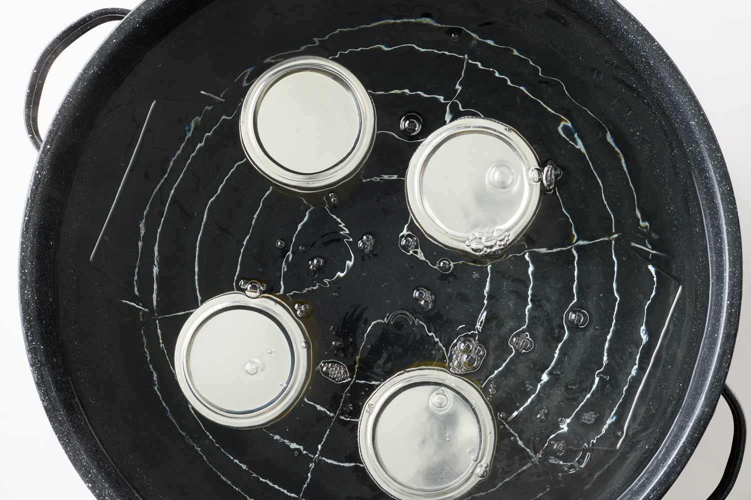 Jars sealed and submerged in a pot for water bath canning