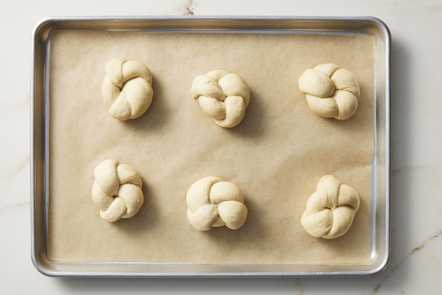 Knotted dough on baking sheet