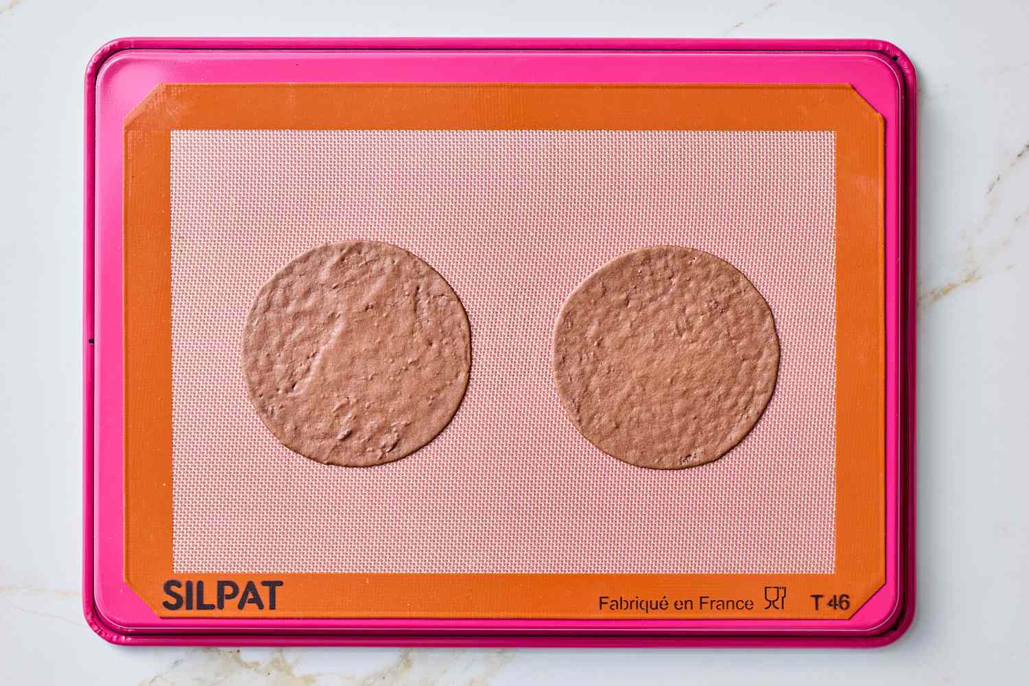 Two baked rounds on a silicone baking mat