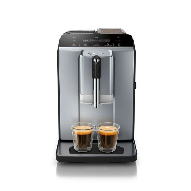 An espresso machine with two cups of coffee brewed on its tray