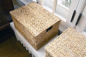 Wicker box with another on a white surface near windows