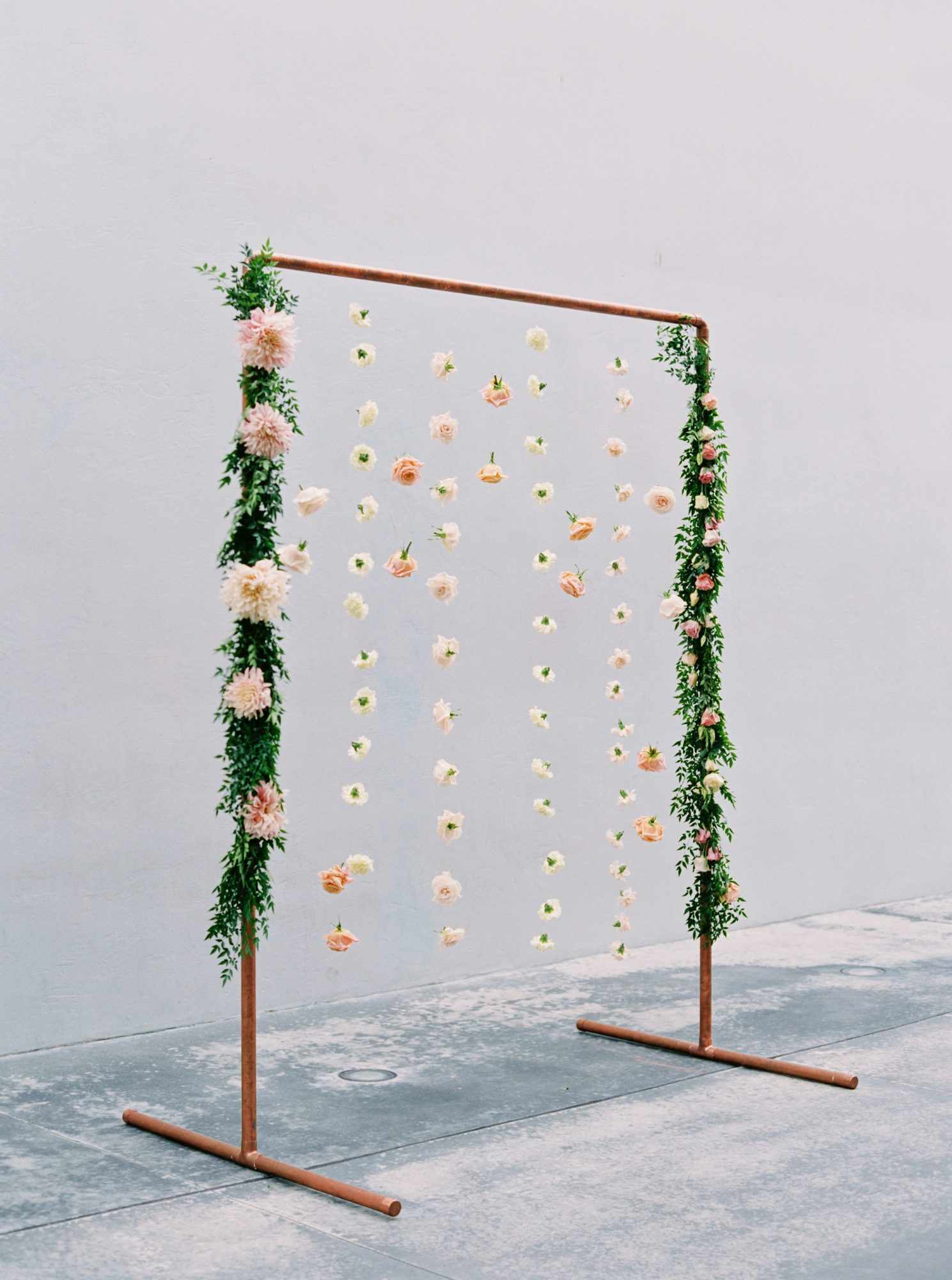 dahlias and carnations suspended from copper frame