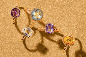 Assorted birthstone rings displayed on a textured surface