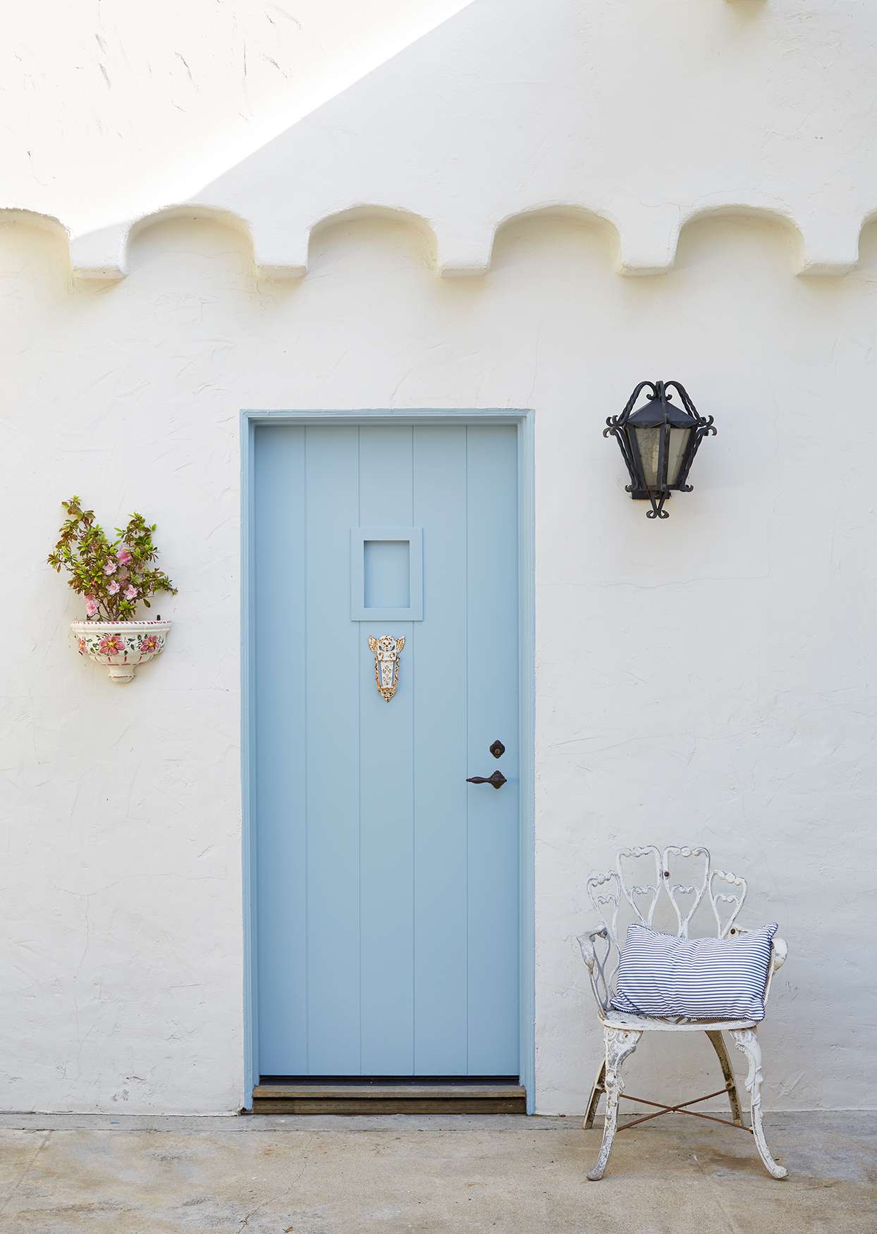 sky blue door in white stucco house