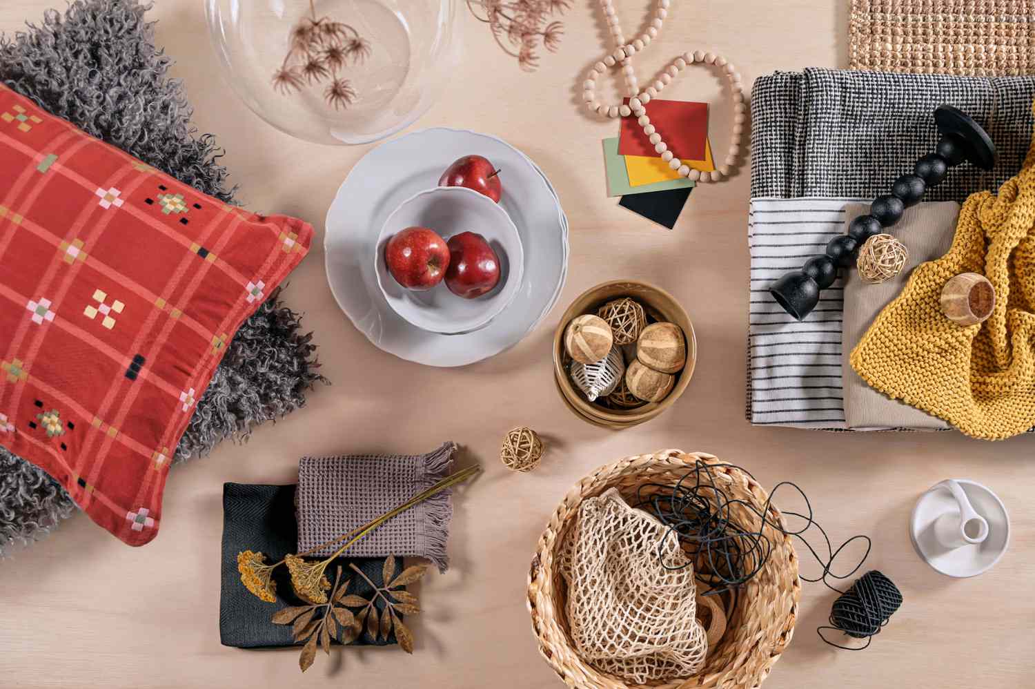 Table with apples, bowls, and more items. 