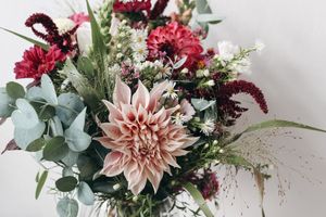 A floral bouquet featuring a variety of flowers and greenery