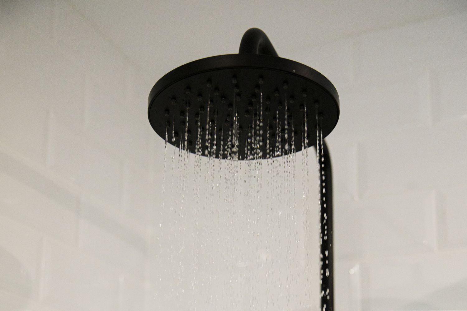 black shower head with water