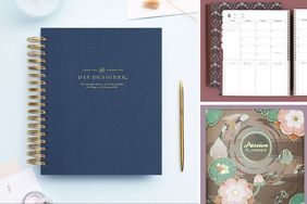 Various planners and notebooks arranged on a table including Day Designer and Passion Planner