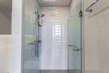 Modern shower stall with glass doors and a showerhead