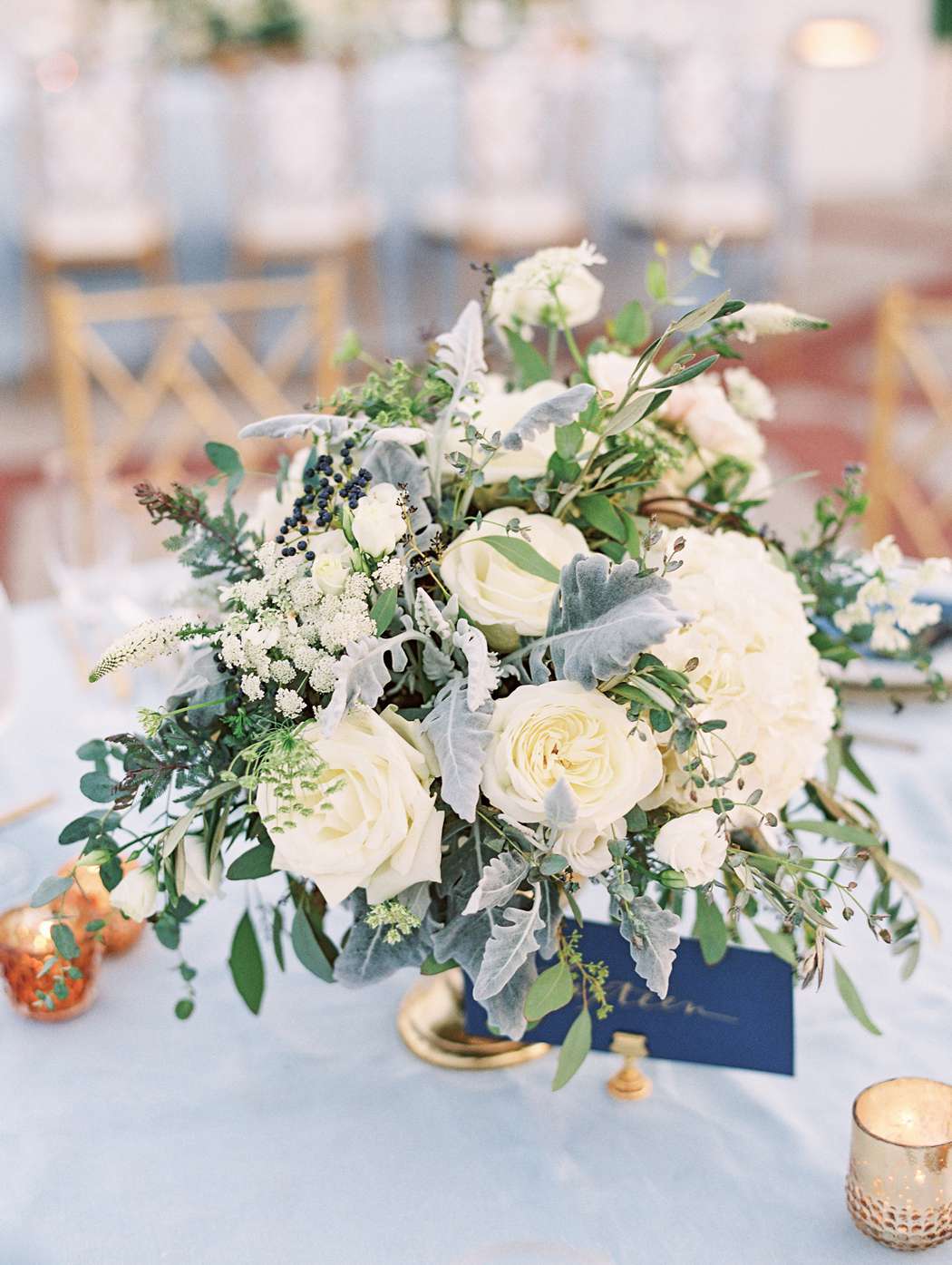 white blooms, lambs ear, and bright foliage in gold vessels centerpieces