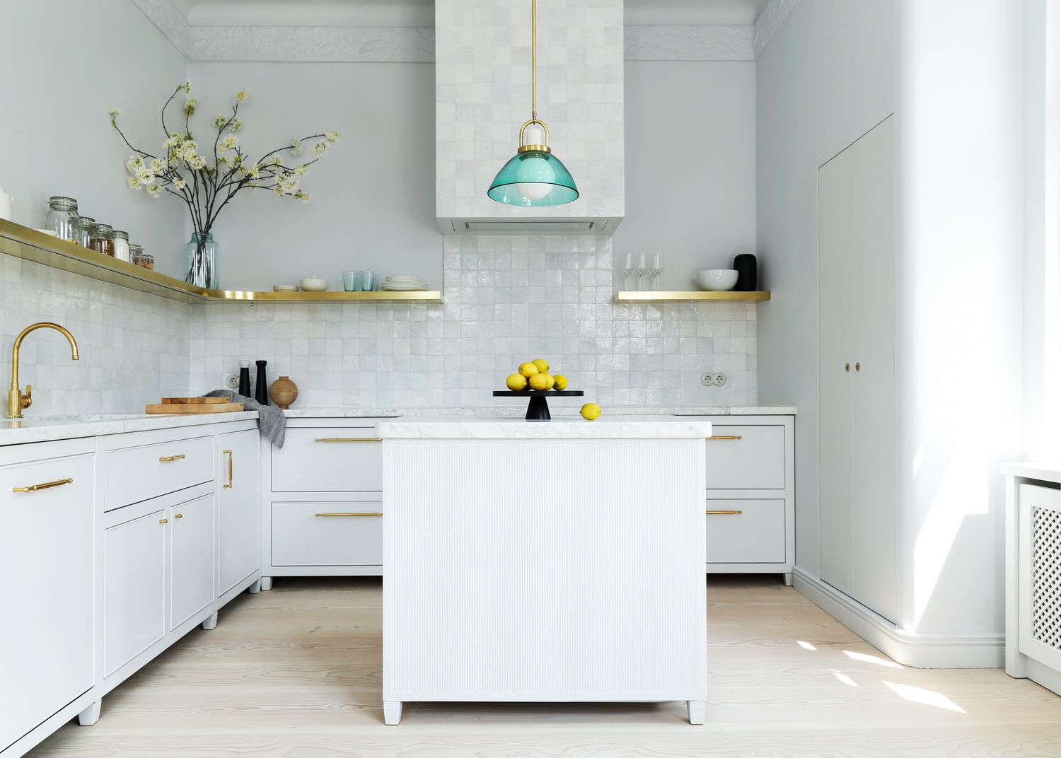 A white kitchen with brass accents