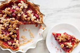 A decorative pie missing a slice with the slice on a separate plate