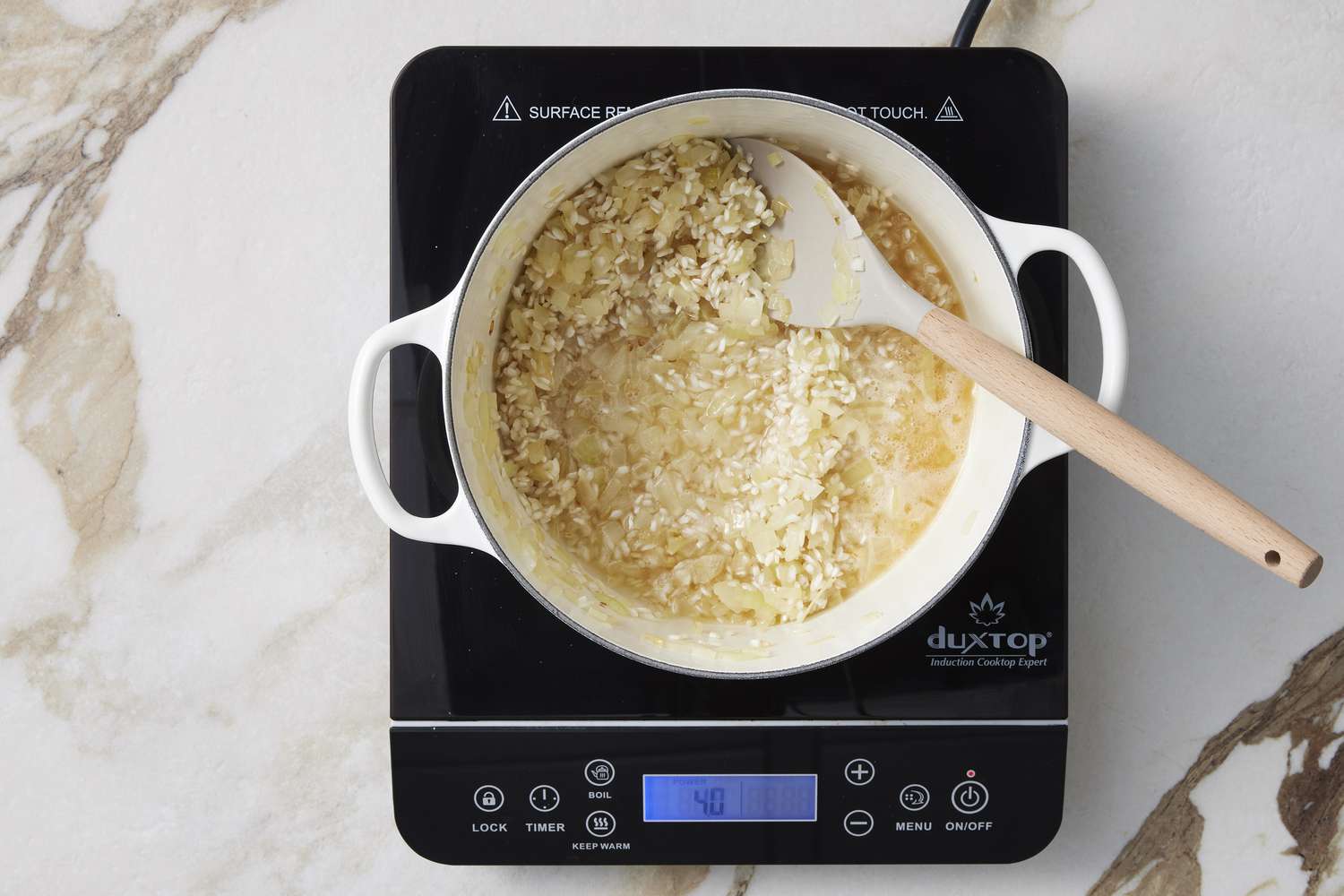 Rice, butter, onion and wine in pot