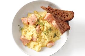 overhead view of salmon and scrambled eggs with toast