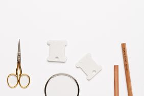 embroidery tools against a white background