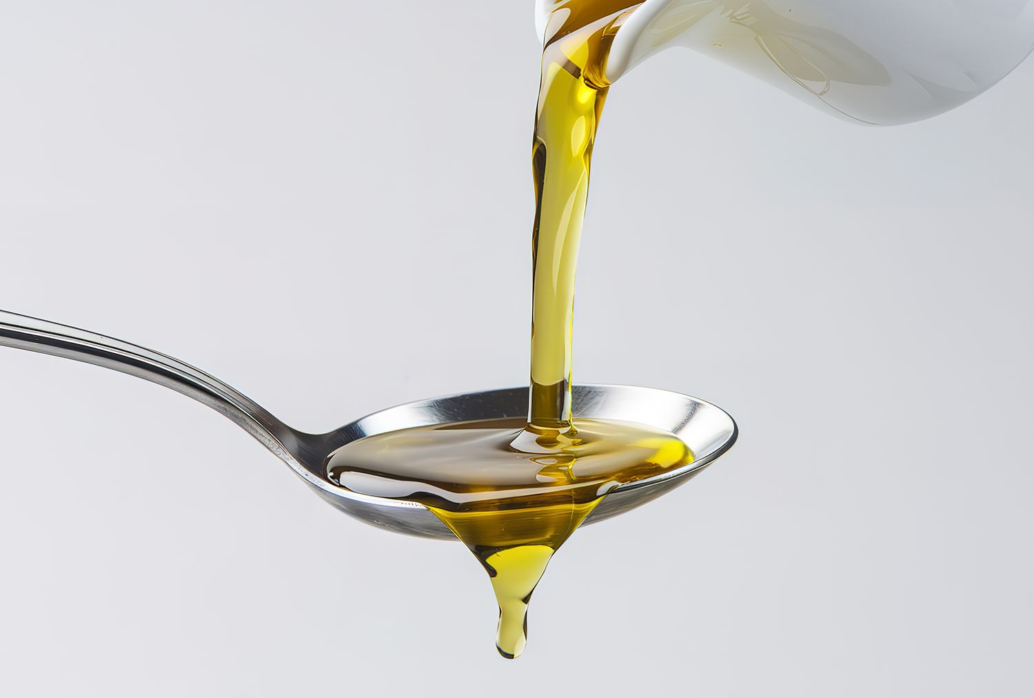 Oil being poured into a spoon