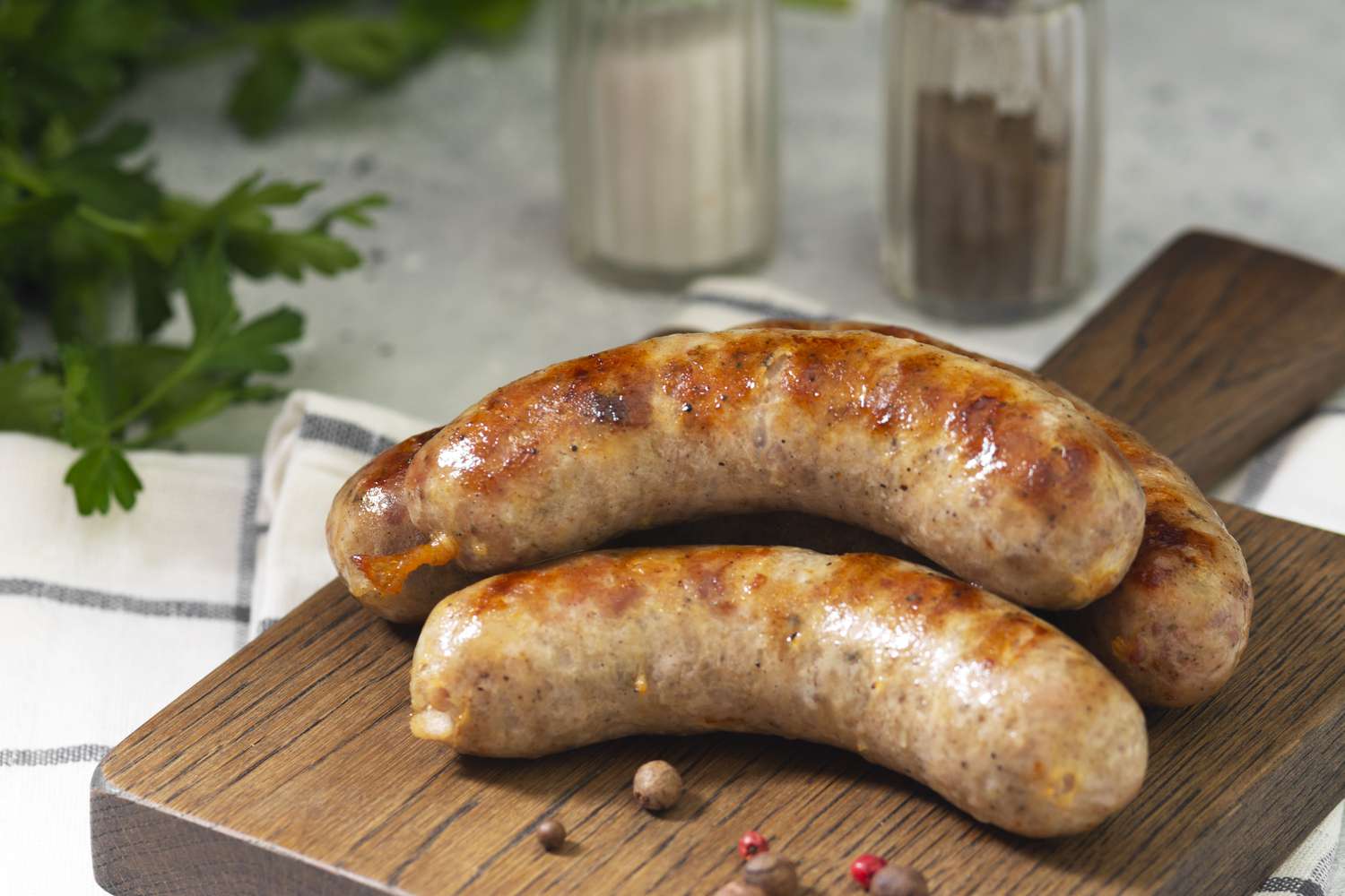 Grilled sausages on a wooden cutting board 