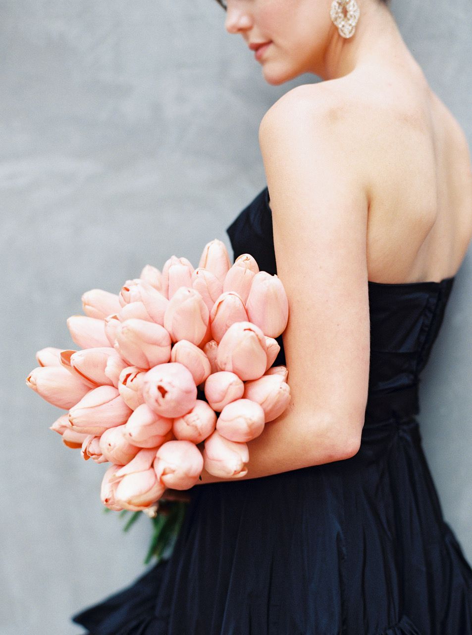 single flower wedding bouquet pink tulips held by bride in black dress