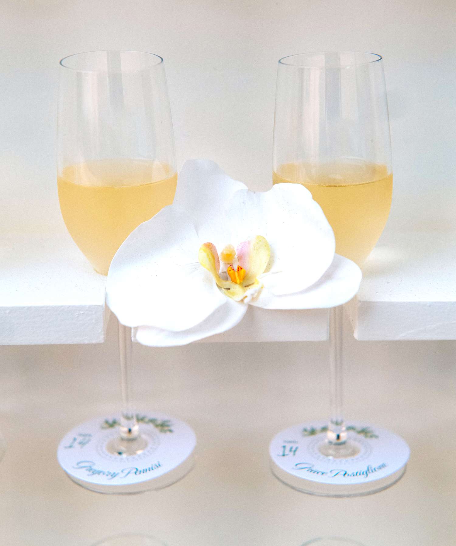 Champagne flutes with cocktail and a flower