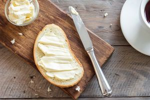 overhead view of bread and butter on a wooden surface