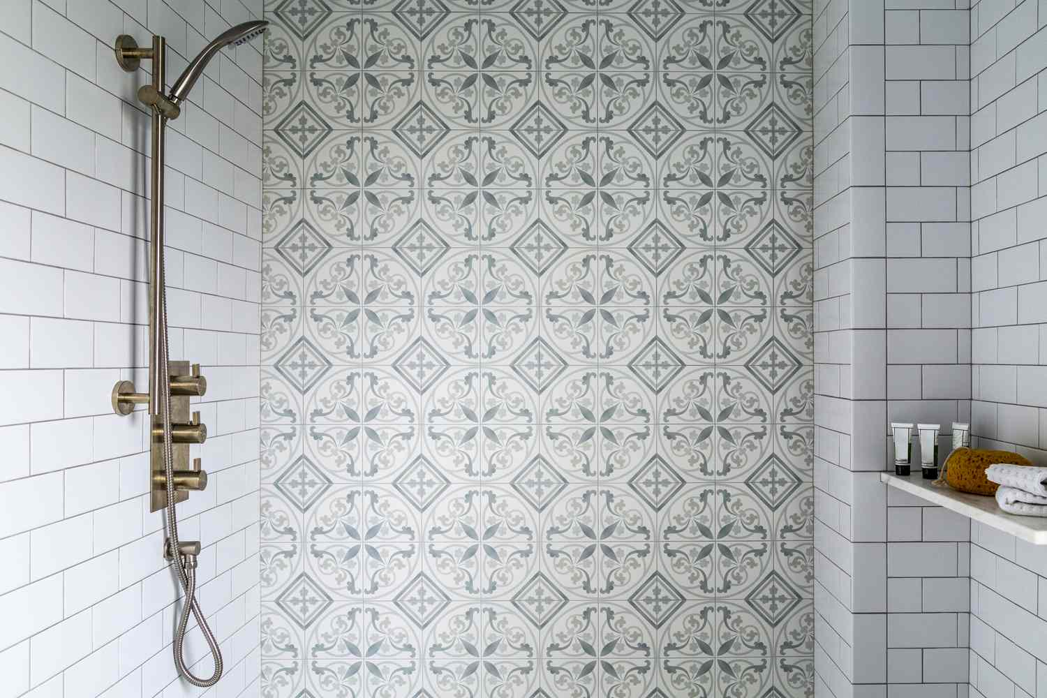 Tiled shower and hand help facucet in bright bathroom with vintage style