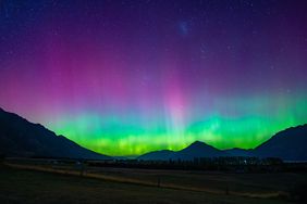 Aurora borealis over a mountainous landscape at night