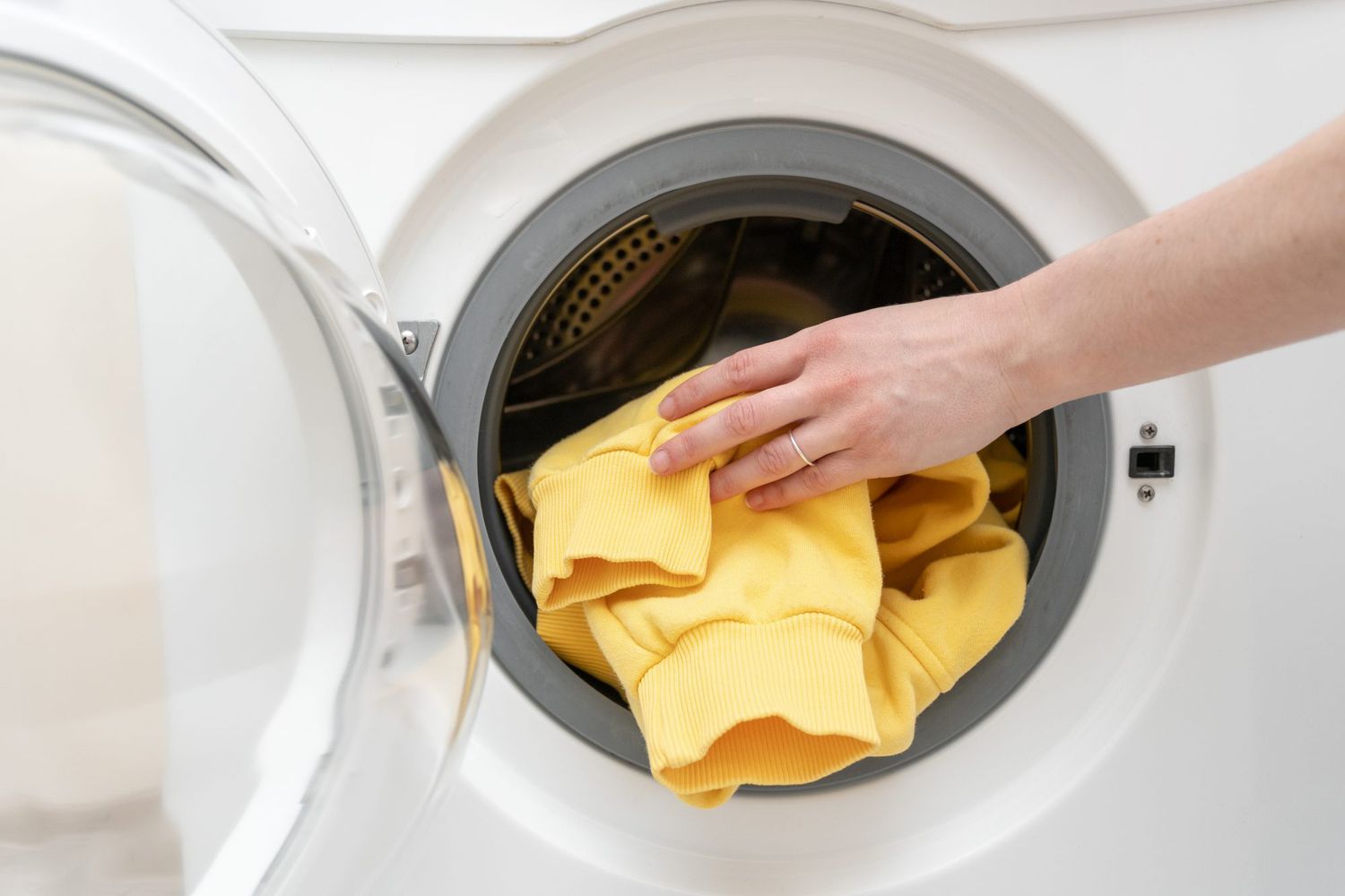 pulling yellow shirt from dryer