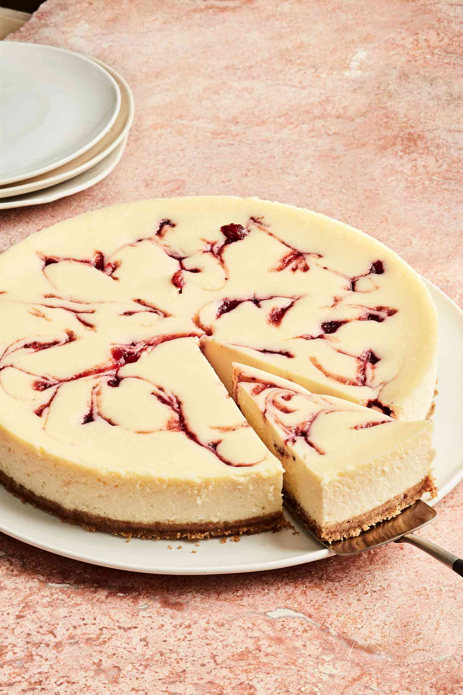 round cranberry cheesecake with slice cut
