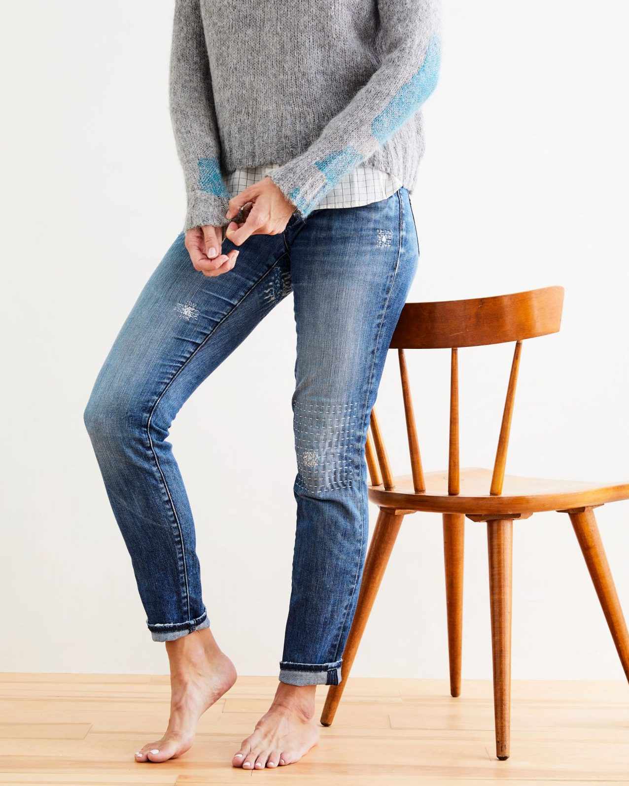 woman wearing mended jeans
