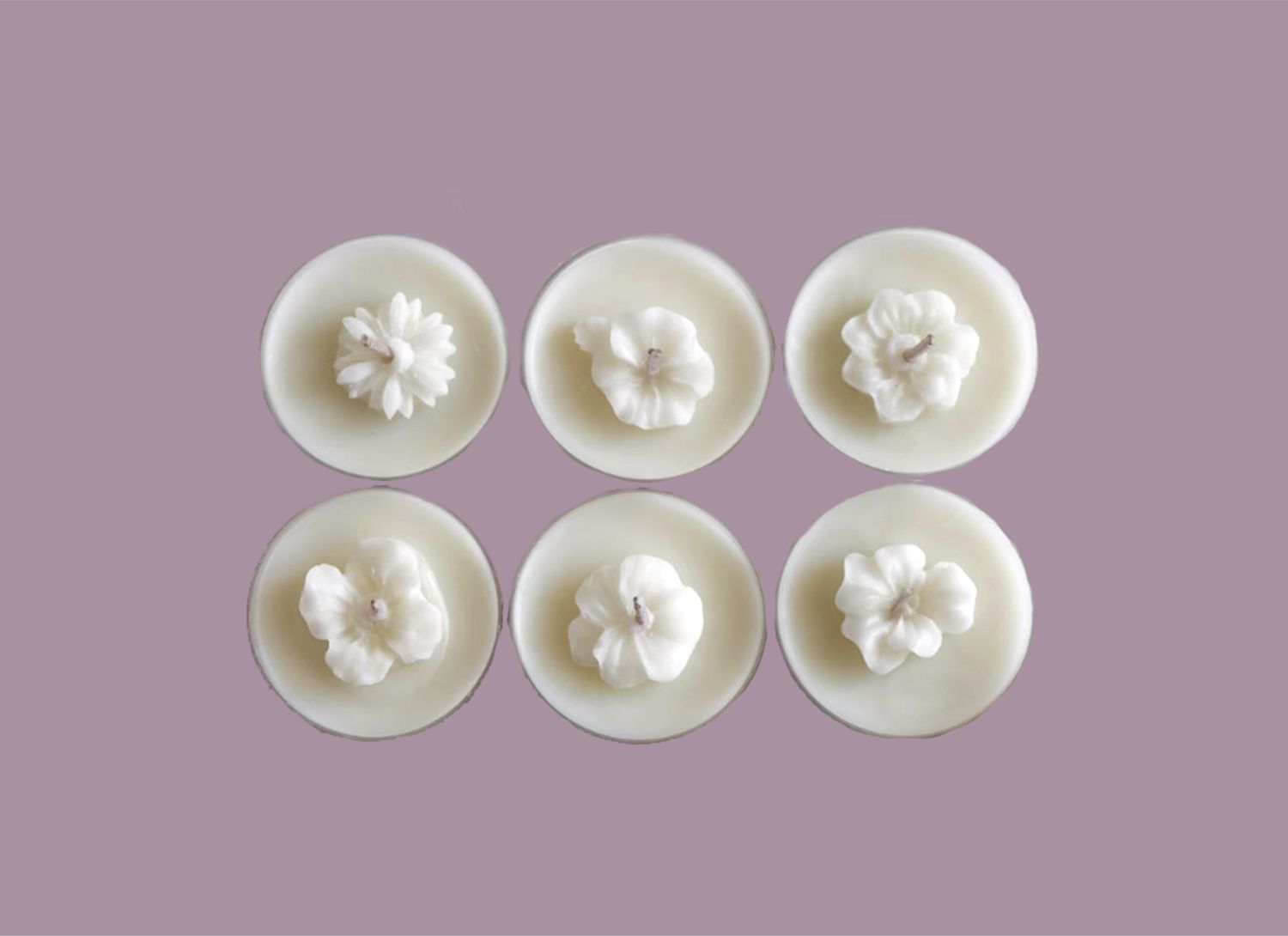 overhead view of multiple tea lights with flowers