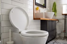 Toilet and sink in a bathroom with tiled walls