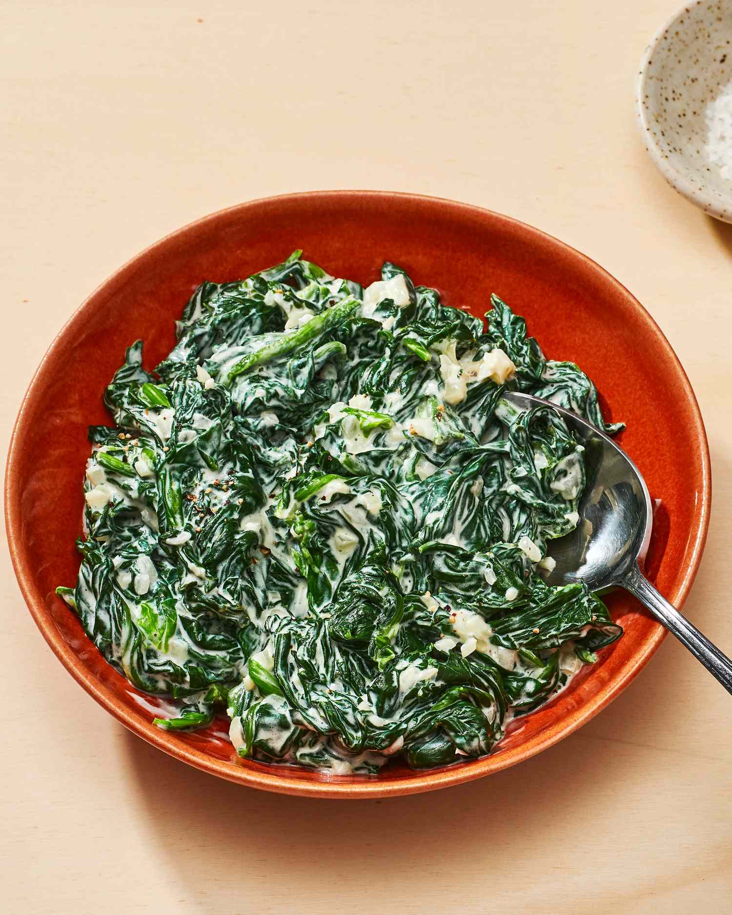 easy creamed spinach in red serving bowl