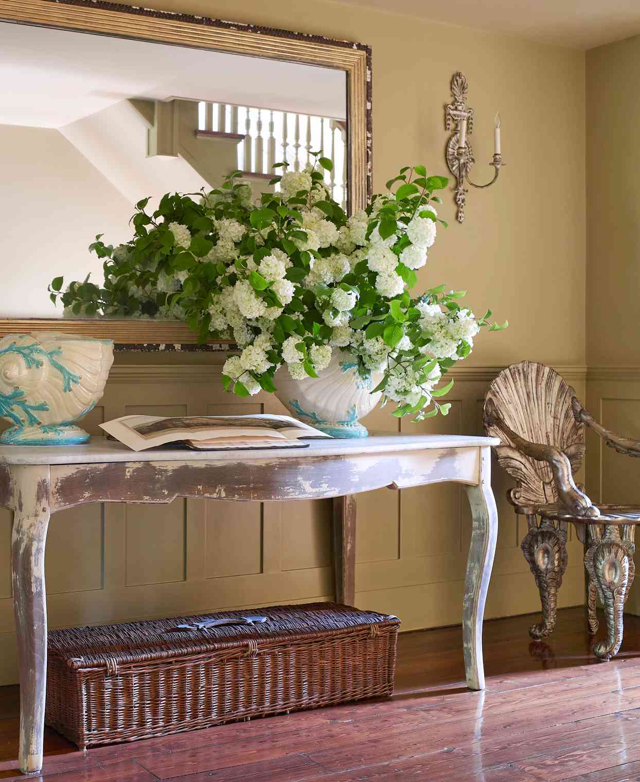 venetian-style shell chairs flank an antique swedish table