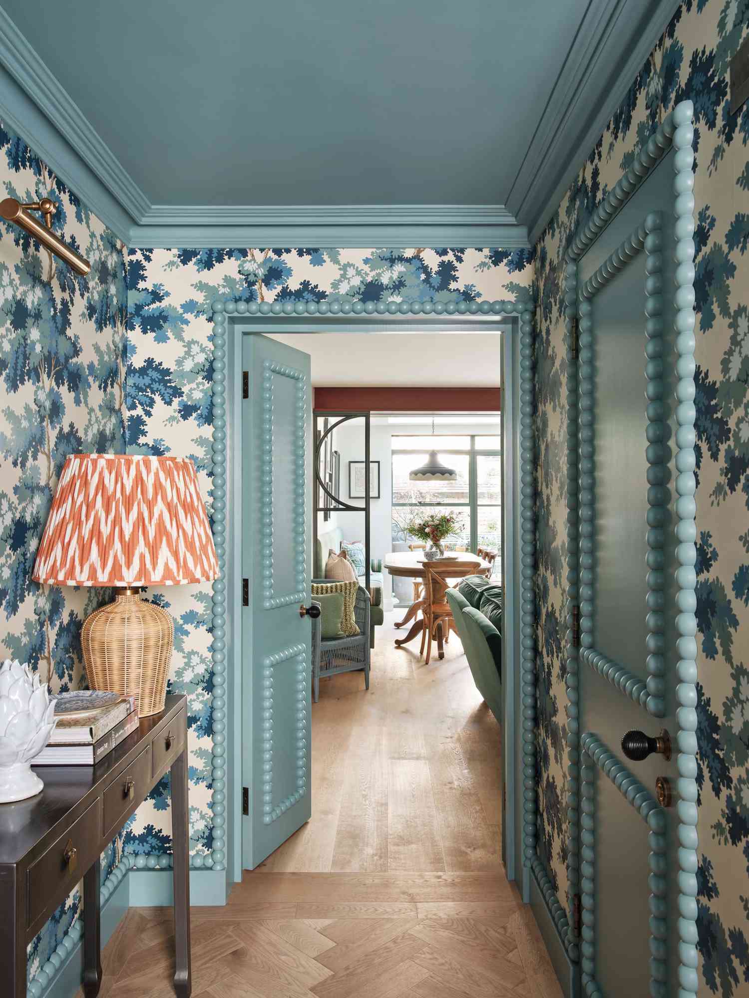 blue wallpaper and orange lamp in hallway
