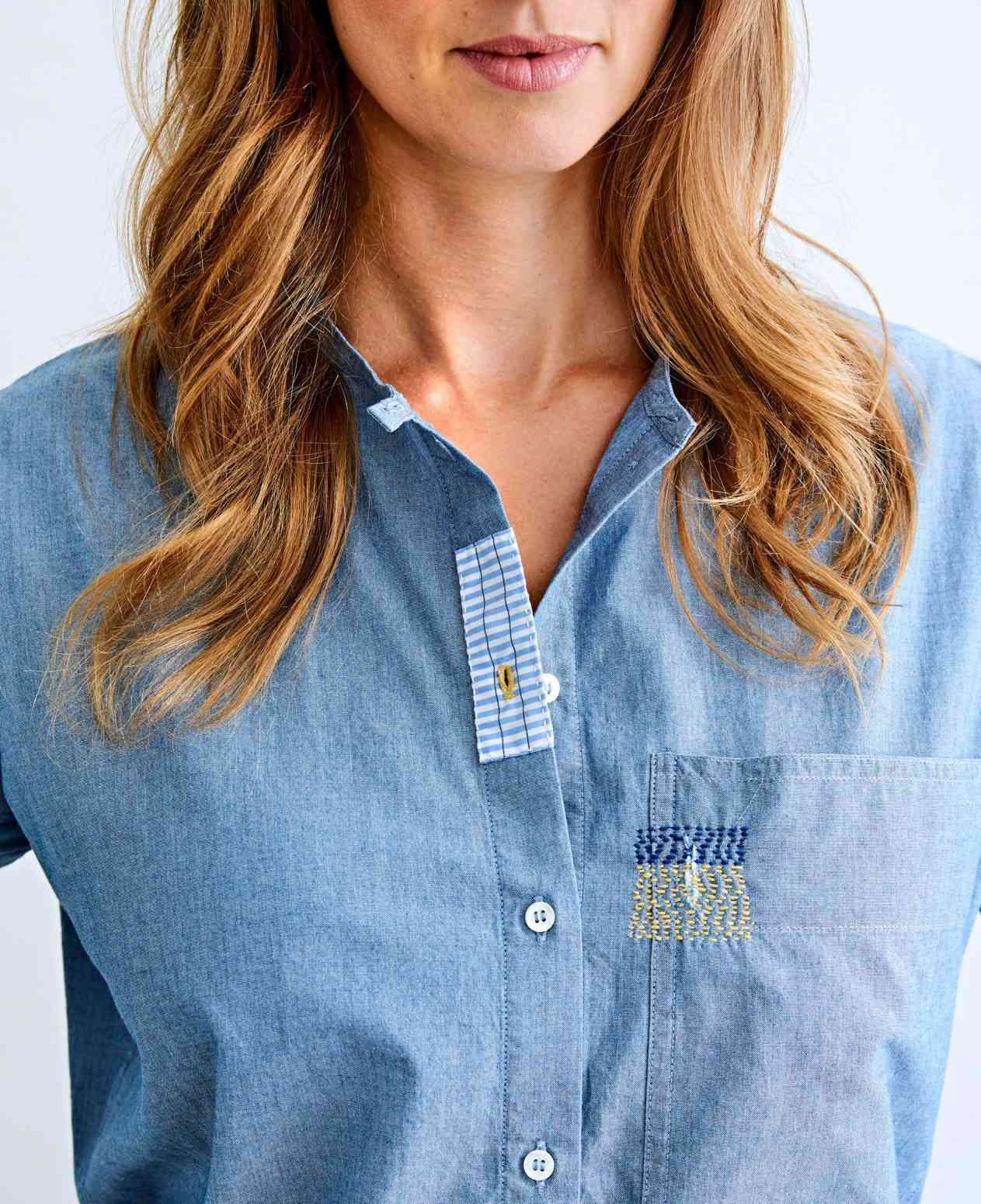 woman wearing a mended denim shirt