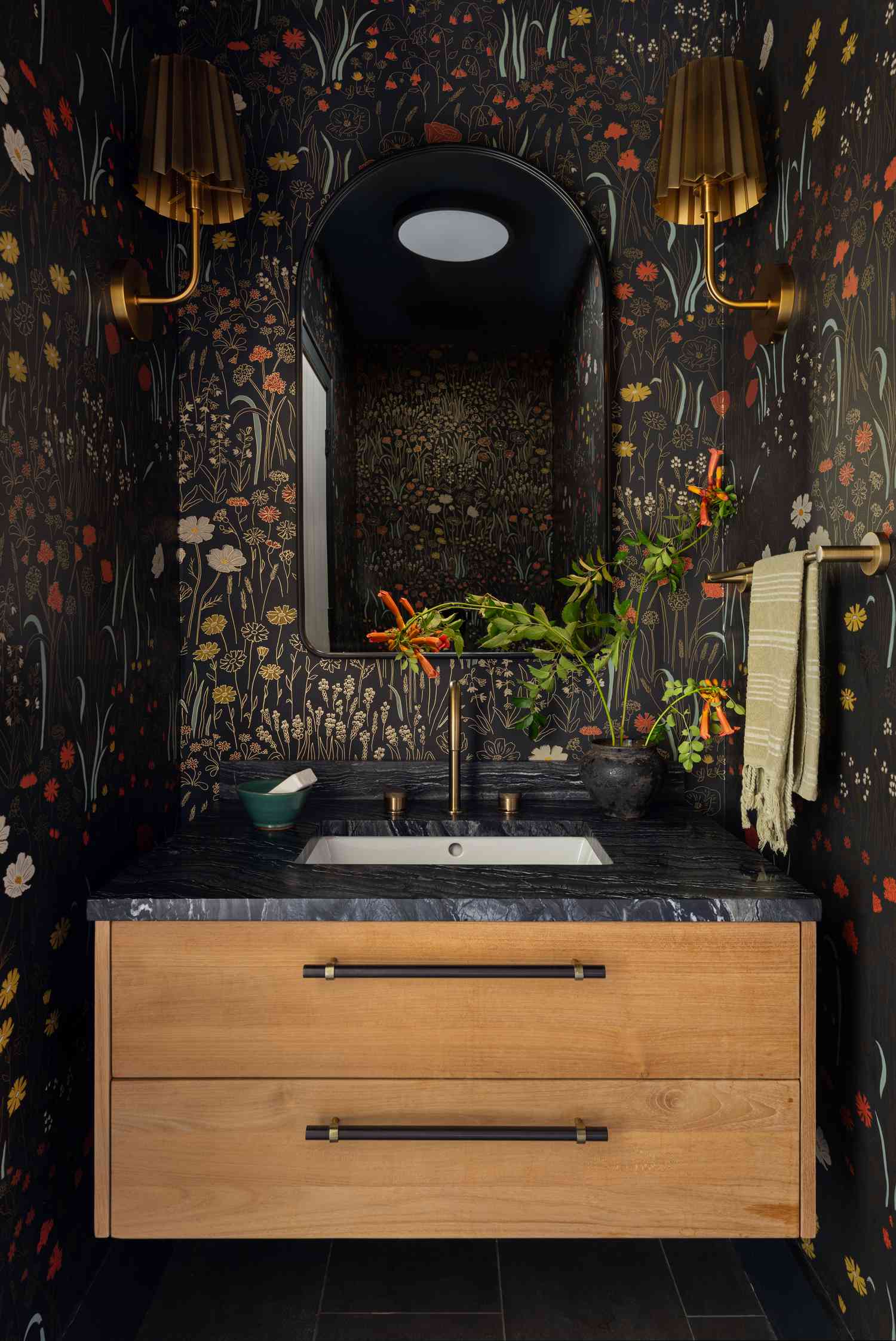powder bath with dark floral wallpaper and bronze accents