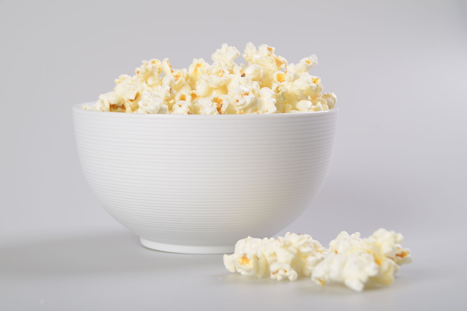 Isolated Caramel popcorn in white bowl.