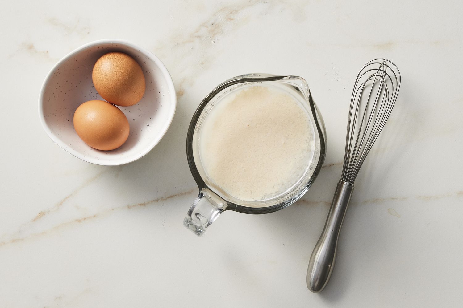 Milk, honey and eggs with whisk