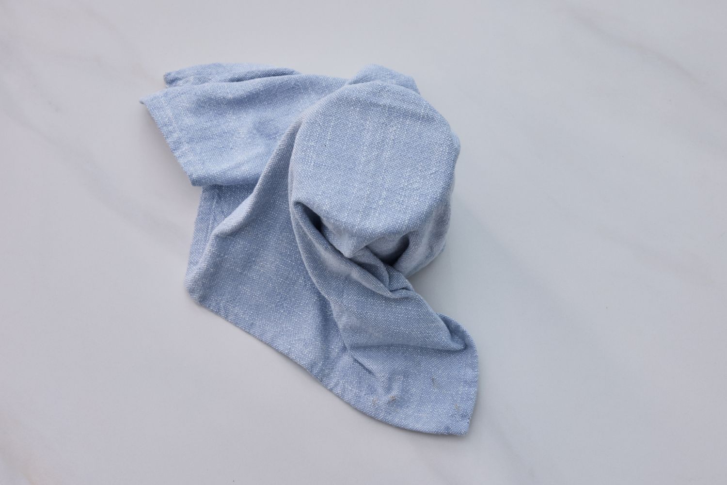 A cloth covering a bowl or container part of a sourdough starter preparation process