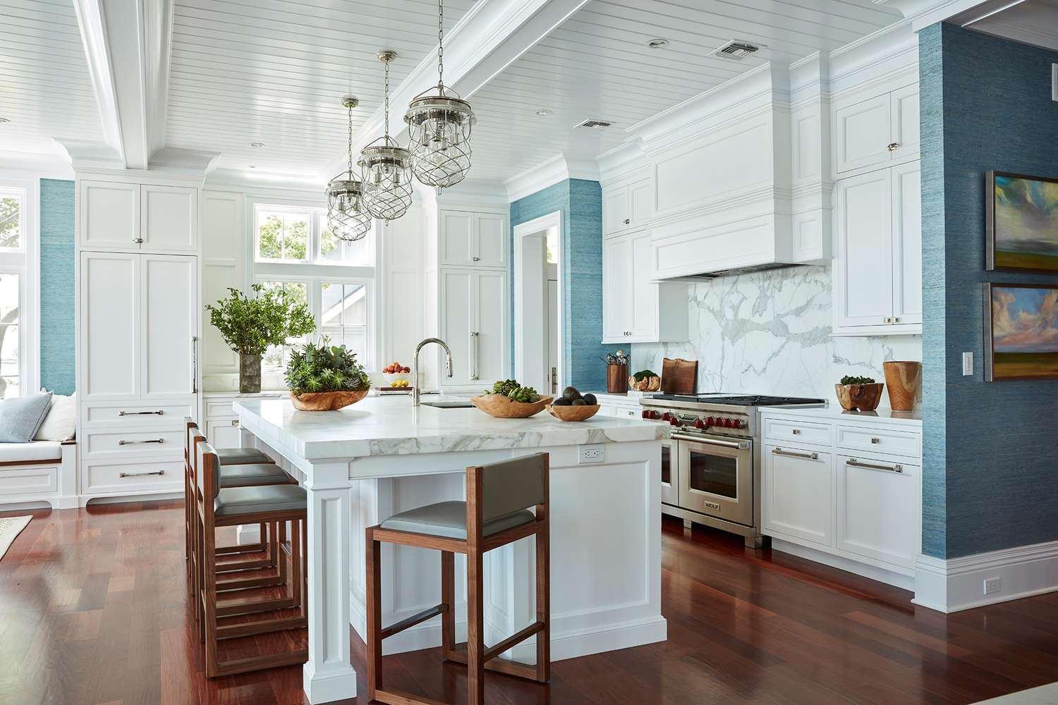 white marble backsplash in blue kitchen